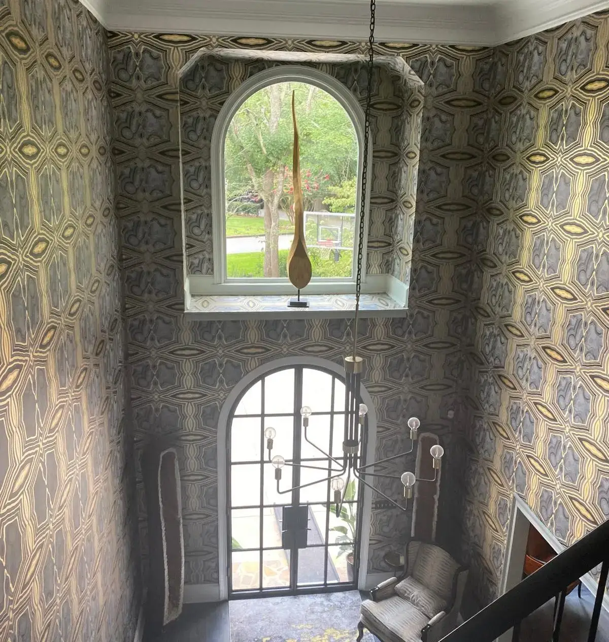 two story home entryway with wallpaper
